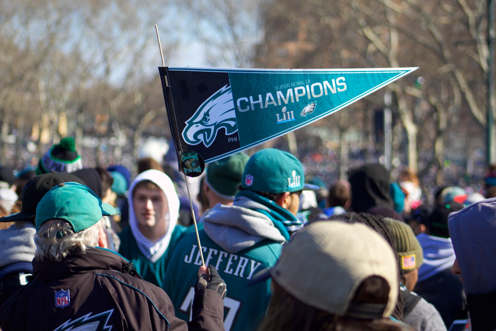 man holding Philadelphia Eagle pennant